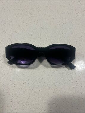 Gucci Black Frame Sunglasses with Purple Lenses